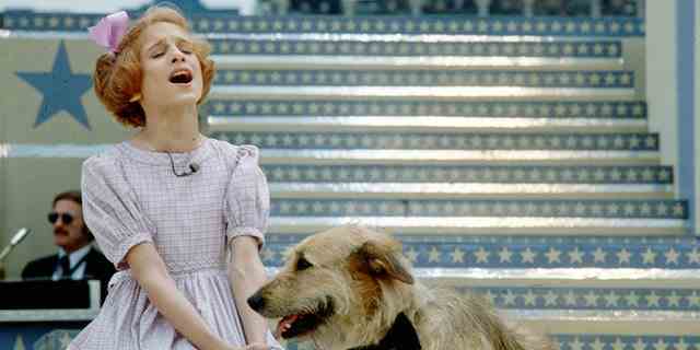 Actress Sarah Jessica Parker performs a scene with a dog in the musical "Annie."