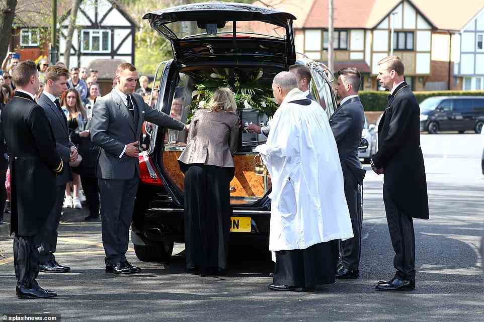 Final kiss goodbye: Kelsey was seen embracing the coffin before it was driven away in the hearse