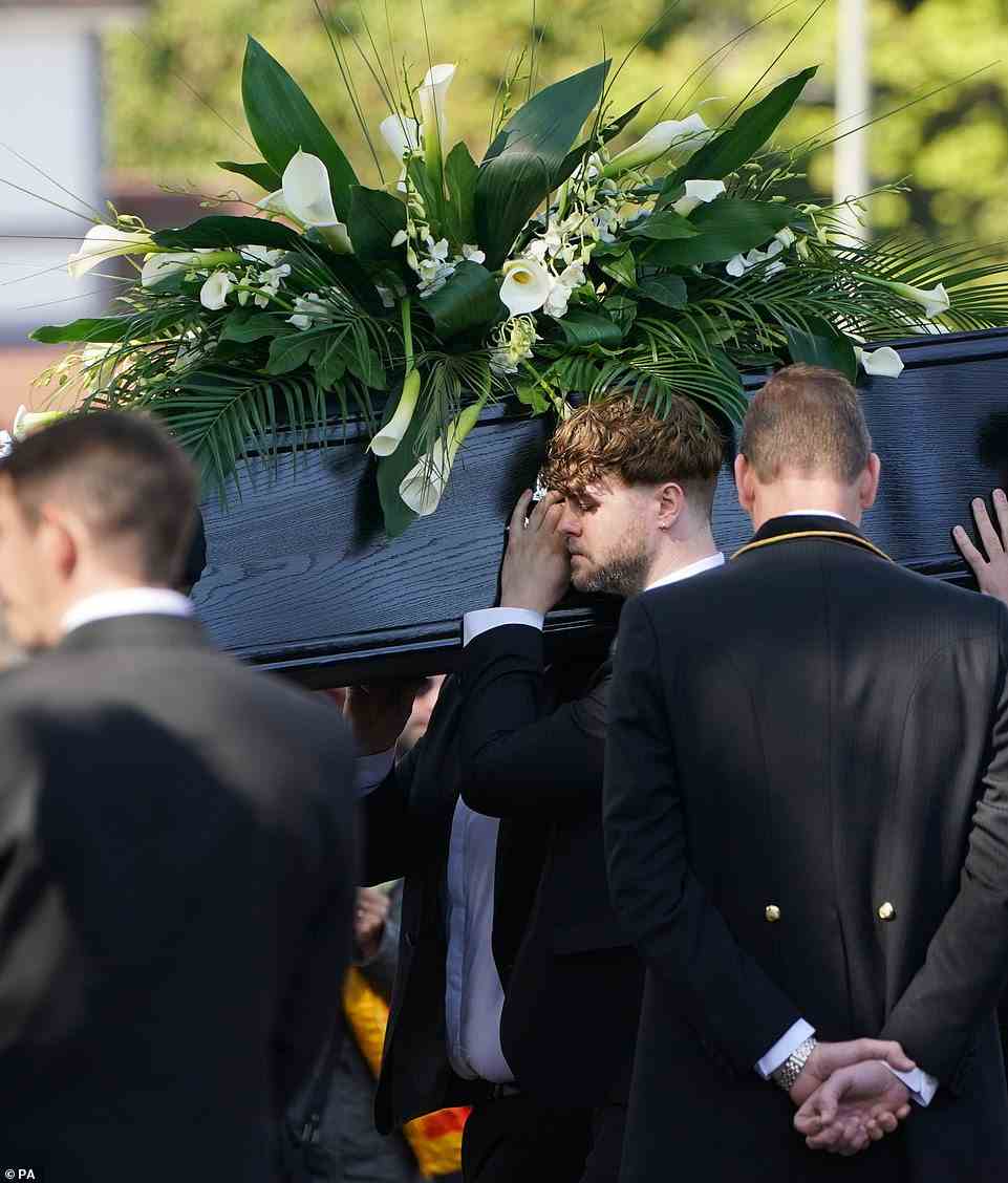 Close: Jay was in tears as he joined his bandmates and other pallbearers to carry the coffin into the church, whole Oasis track Champagne Supernova played