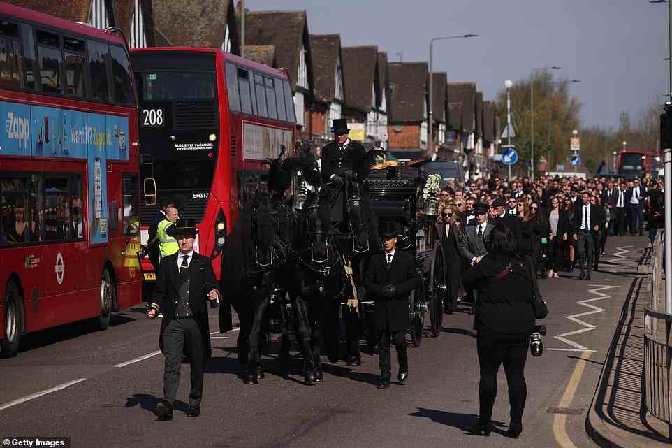 Lining the streets: The Wanted joined hundreds of fans to pay their respects as the hearse travelled through Pett's Wood in South East London