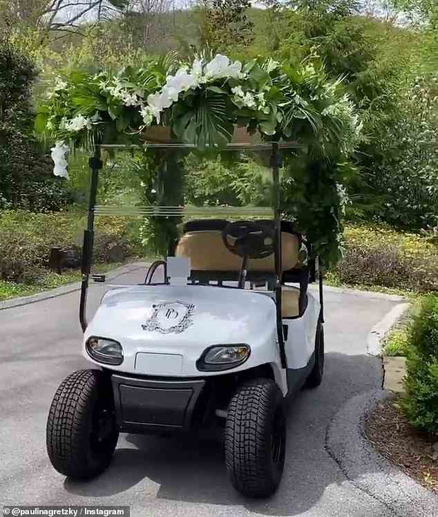 The couple was greeted with a golf cart with their initials 'P' and 'D' that was decorated with white flowers and greenery in celebration of their big day