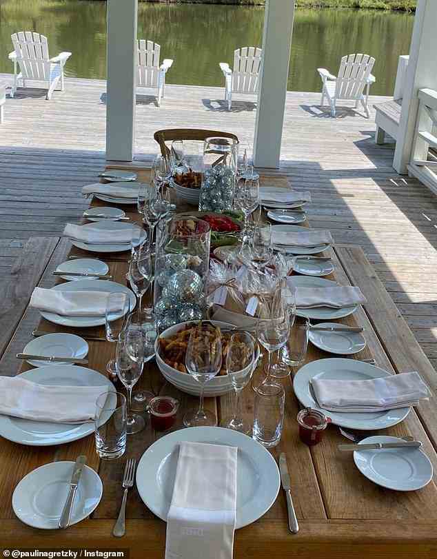 Inside the boathouse, there was a picnic table set for ten, glass vases filled with mini disco balls, and disco balls of all different sizes hanging from the ceiling