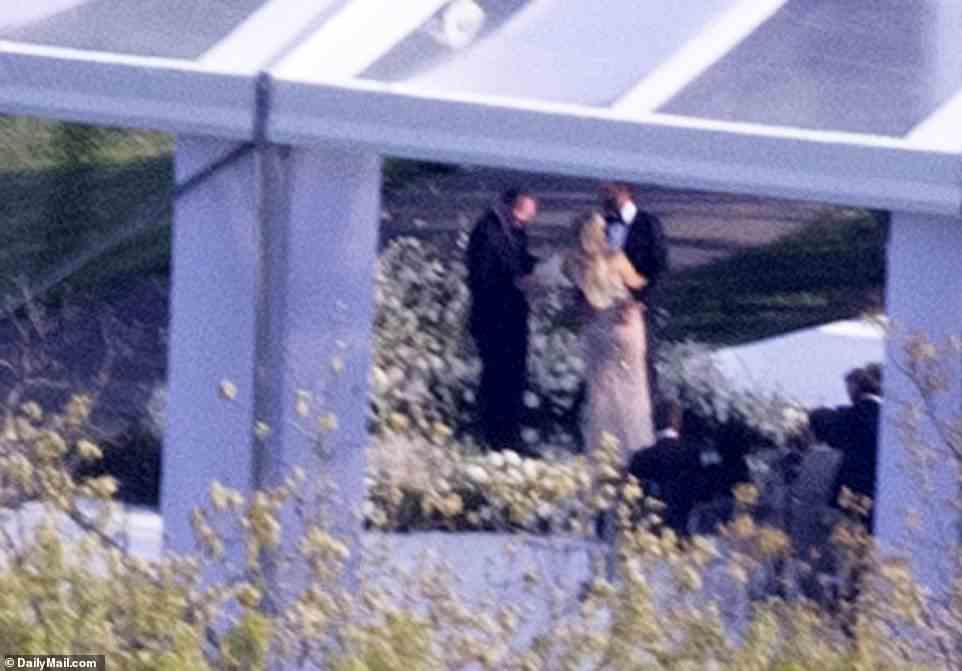 Photos show the happy couple exchanging vows under tent erected on the compound's spacious lawn