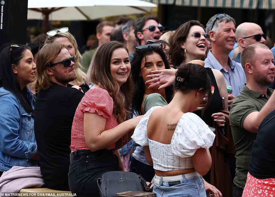 A group of women smile for the camera as they enjoy drinks in Sydney's CBD after ANZAC Day commemorations