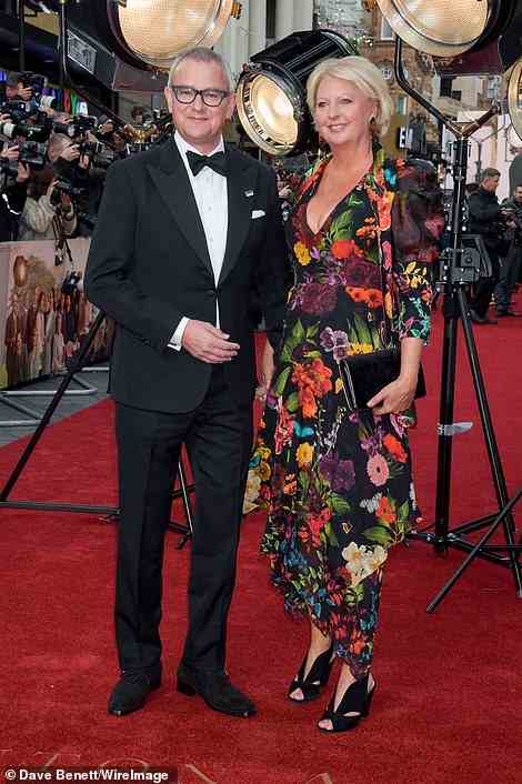 Couple: Hugh appeared to be in jubilant spirits as he posed alongside his wife Lulu Williams