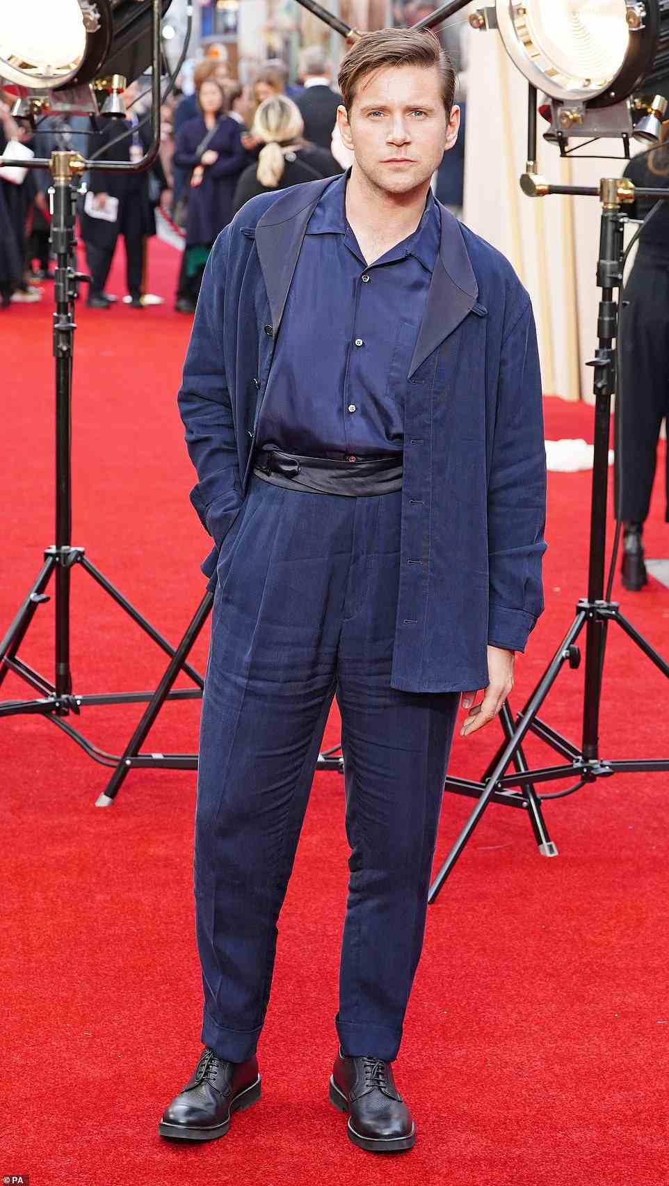 Smouldering: Allen looked stylish in high-waisted navy trousers, which he wore with a black wrap-around belt and a blue shirt and jacket