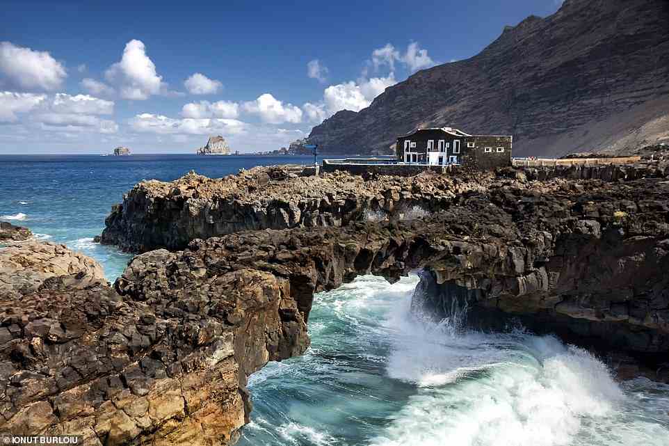 Surrounded on three sides by water, adults-only hotel Puntagrande, pictured, is set at the tip of a tongue of lava rock on El Hierro