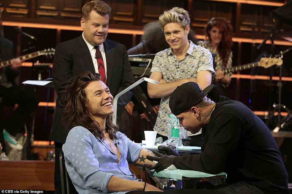 Oh no! Harry Styles (bottom left) ended up losing a game of Tattoo Roulette with James on the Late Late Show, meaning he had to have the programme's name inked onto him (pictured in 2015)