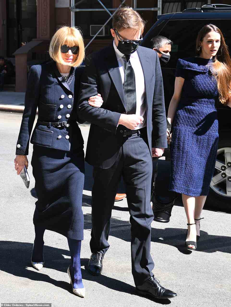 She clutched tightly to her son, Charles - a 37-year-old doctor who kept it simple in a black suit. They were joined by Wintour's daughter, Bee Shaffer, 34, who opted for a tight-fitting indigo dress