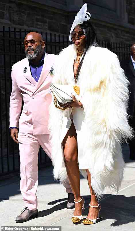 Campbell was accompanied by a dapper gentleman wearing a pale pink suit; she also added a unique touch to her ensemble with a pair of funky heels that had gold toe details on them