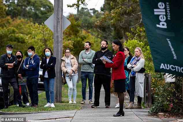 Australians are being warned to prepare for higher interest rates as the Reserve Bank of Australia gives its biggest hint that it will increase rates this year (pictured is an auction at Glen Iris in Melbourne)