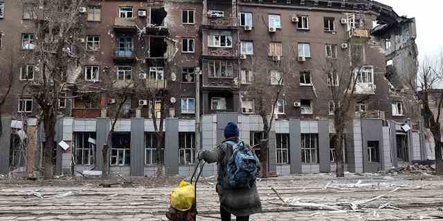 Ein Anwohner betrachtet am Samstag, den 16. April 2022, ein beschädigtes Gebäude nach schweren Kämpfen in der Nähe des Hüttenwerks Illich Iron and Steel Works in einem Gebiet, das von russisch unterstützten Separatisten in Mariupol kontrolliert wird. 