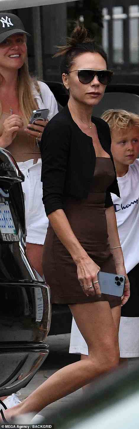 Wow! Victoria Beckham flashed her legs in a tight brown minidress as she left her £5m Miami superyacht with her husband David and their kids Harper, 10, and Romeo, 19, ahead of their eldest son Brooklyn's wedding to Nicola Peltz