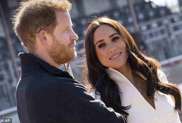 Prince Harry and Meghan Markle are seen smiling while they visit the track and field event at the Invictus Games in The Hague, Netherlands on April 17, 2022