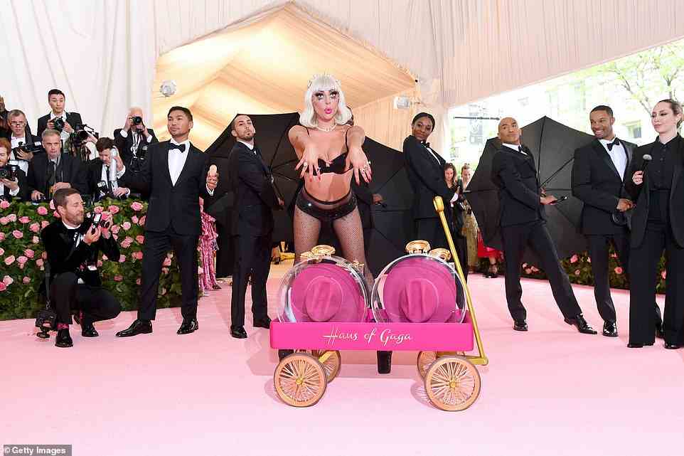 Gaga was accompanied by a team of dapper men and women wearing suits, and she also carted a custom-made Haus of Gaga wagon along the red carpet with her