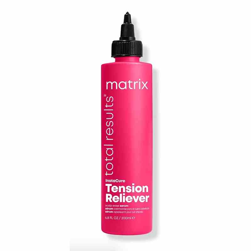A pink bottle of the Matrix Total Results Instacure Tension Reliever Scalp Serum on a white background