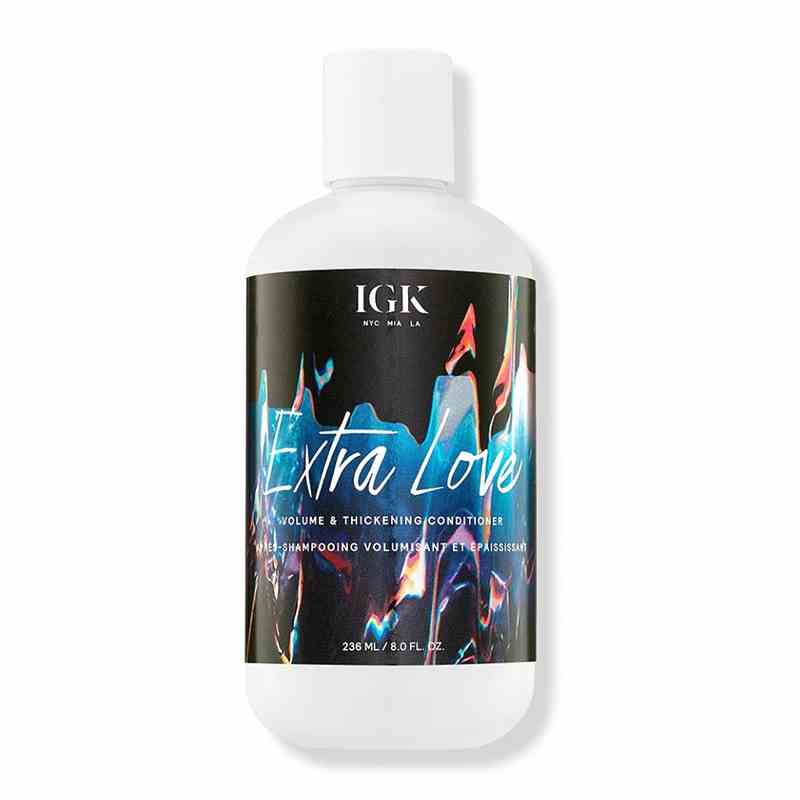 A white, black, and blue bottle of the Extra Love Volume & Thickening Conditioner on a white background