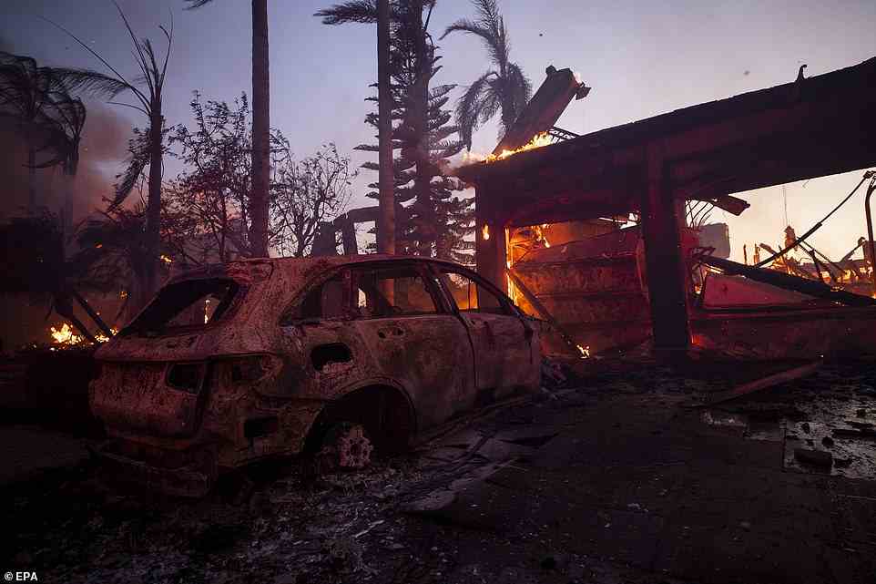A house and a car are destroyed by the Coastal Fire in Laguna Niguel in California on Wednesday. Around 200 acres have been destroyed by the fire