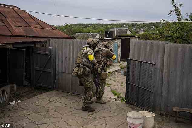 Ukranian National Guard soldiers take positions during a reconnaissance mission in a recently retaken village in the outskirts of Kharkiv