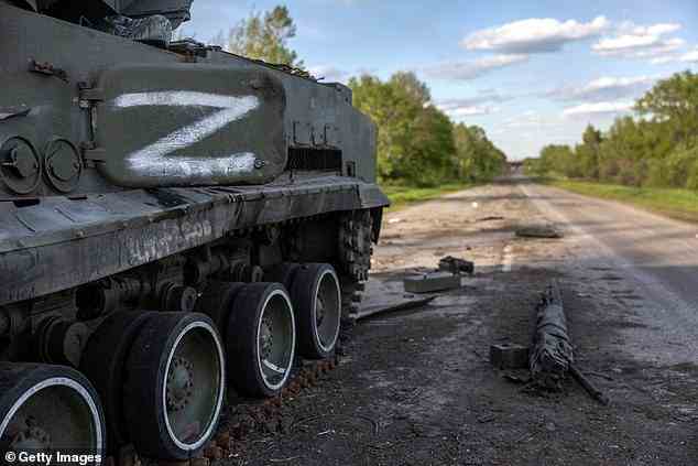 Pictured: A destroyed Russian armored vehicle pictured on May 13, 2022 on the northern outskirts of Kharkiv, Ukraine. Russian forces will instead focus on launching mortar, artillery and airstrikes in the eastern Donetsk province in order to 'deplete Ukrainian forces and destroy fortifications'