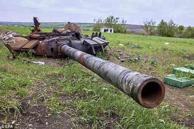 Pictured: A damaged Russian tank turret blown clean off the chassis near the village of Mala Rohan, Kharkiv, Ukraine, 13 May 2022