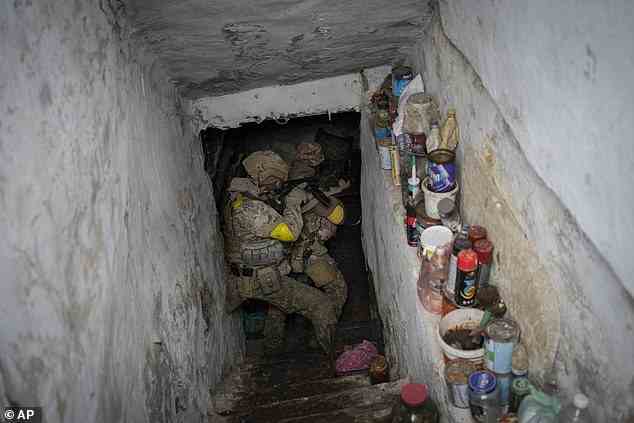 Ukrainian National Guard soldiers inspect a basement during a reconnaissance mission in a recently retaken village on the outskirts of Kharkiv, east Ukraine on May 14