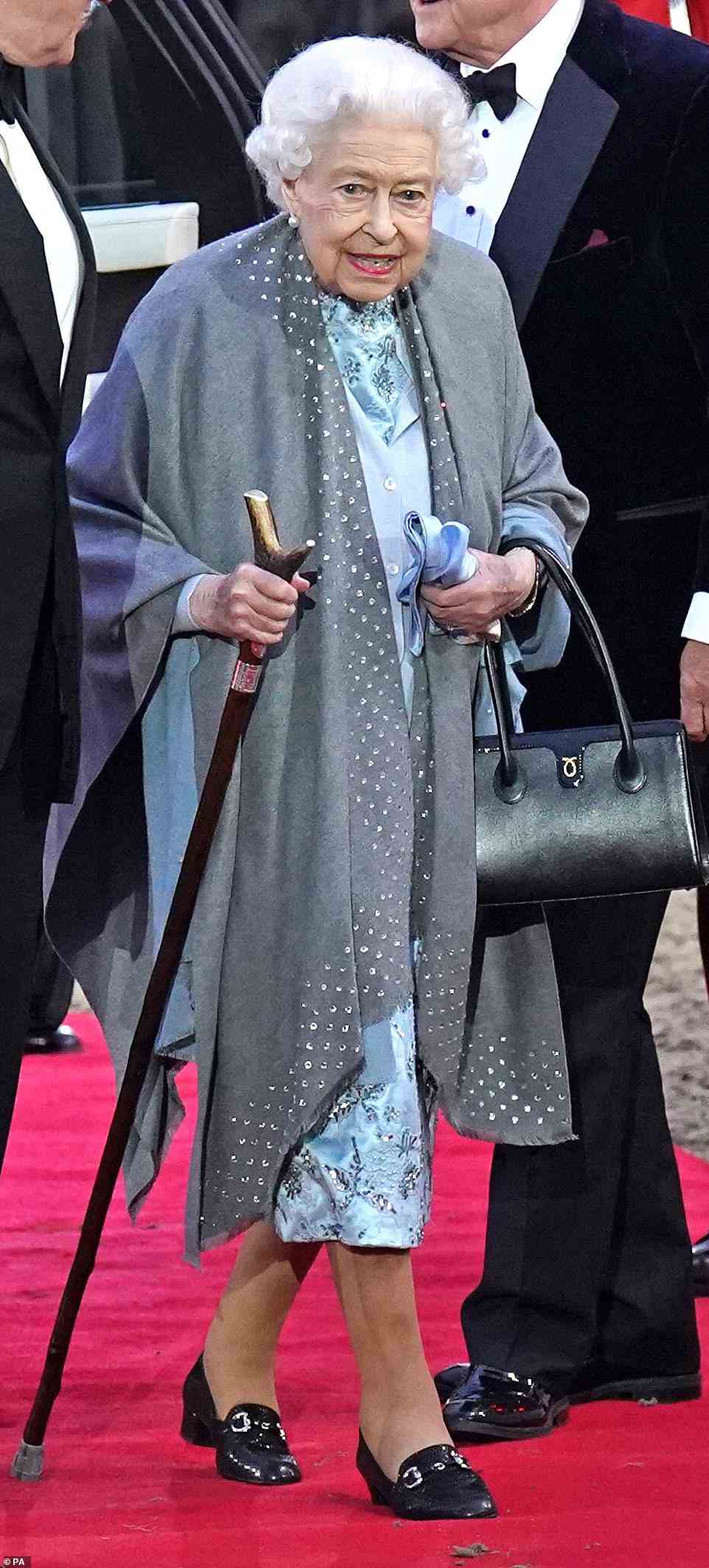 The nation saluted and cheered the 96-year-old monarch exited her Range Rover wearing a glitzy grey cardigan and embellished blue dress, accessorised with black loafers and a handbag.