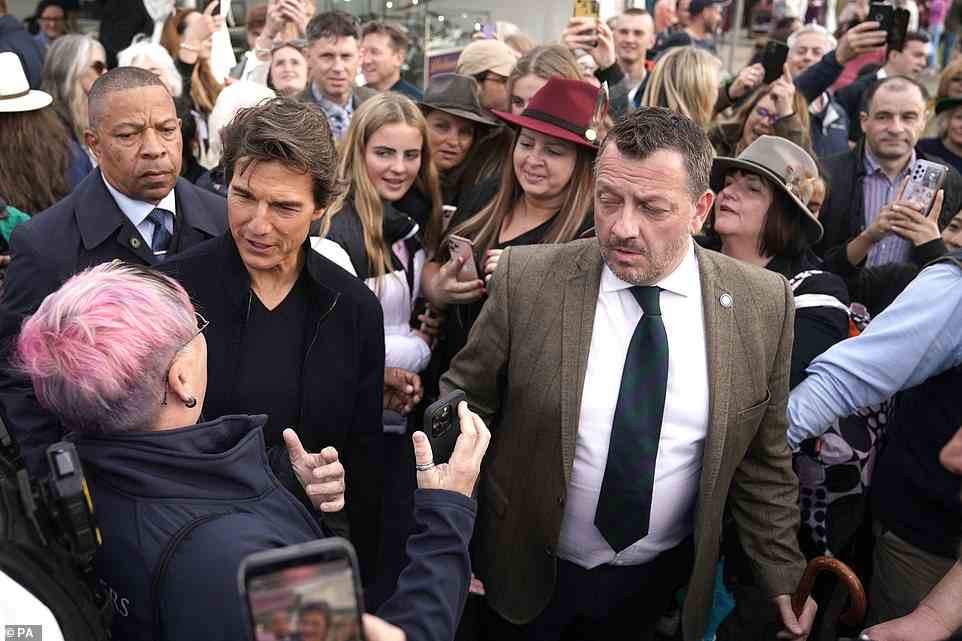 Tom Cruise greets an excited fan at the Royal Windsor Horse Show near Windsor Castle earlier today