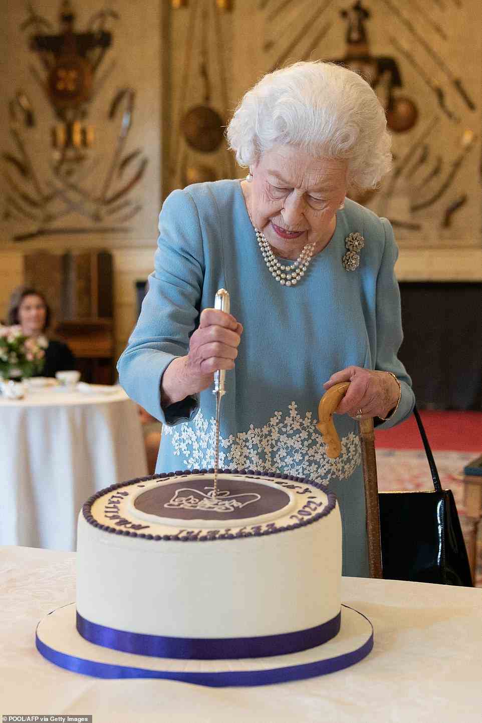 Celebrations for the Queen's Platinum Jubilee will include the Red Arrows performing overhead at RAF Cosford, jousting at Hampton Court Palace and Sir Elton John performing at a special concert at Buckingham Palace. Pictured: The Queen cuts a cake to celebrate the start of the Platinum Jubilee on February 5 2022