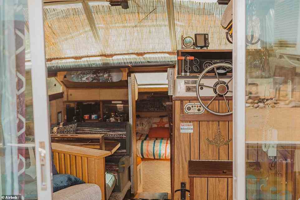 Climb aboard and there's one bedroom, a living space, kitchen with cooker and running water, and even a helm complete with a captain's steering wheel