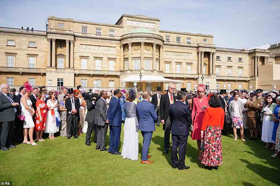 Centre of the action: Guests waited patiently for the opportunity to speak to the Duchess of Cambridge at the garden party