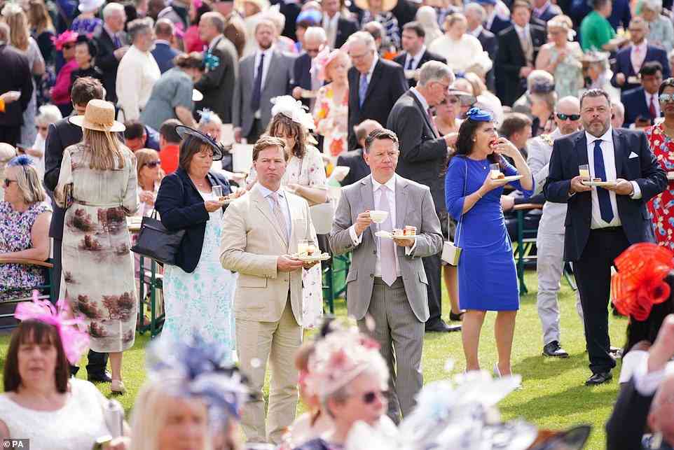 A royally good time! Every year, the Queen invites 30,000 people to attend the parties. At each Garden Party, around 27,000 cups of tea, 20,000 sandwiches and 20,000 slices of cake are consumed. Pictured, guests at today's event