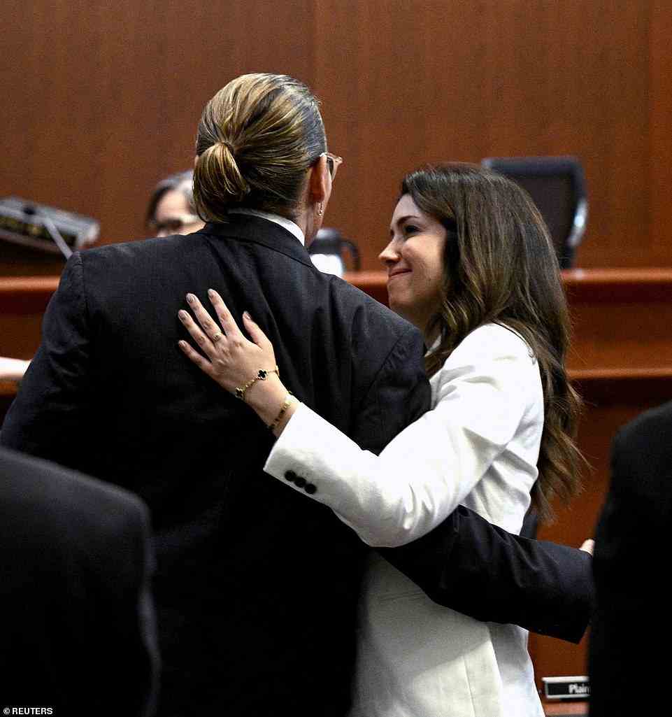 The two were all smiles as they entered the Fairfax County Circuit Courthouse on Wednesday, a day after they were snapped hugging in a photo that was widely shared on social media (pictured)