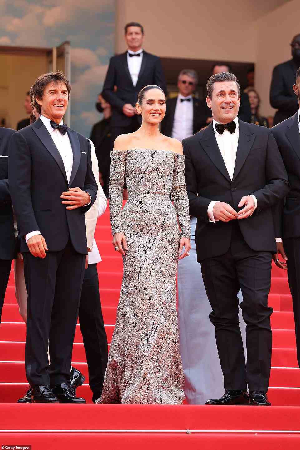 All smiles: Tom and Jennifer were also joined by Jon Hamm on the red carpet