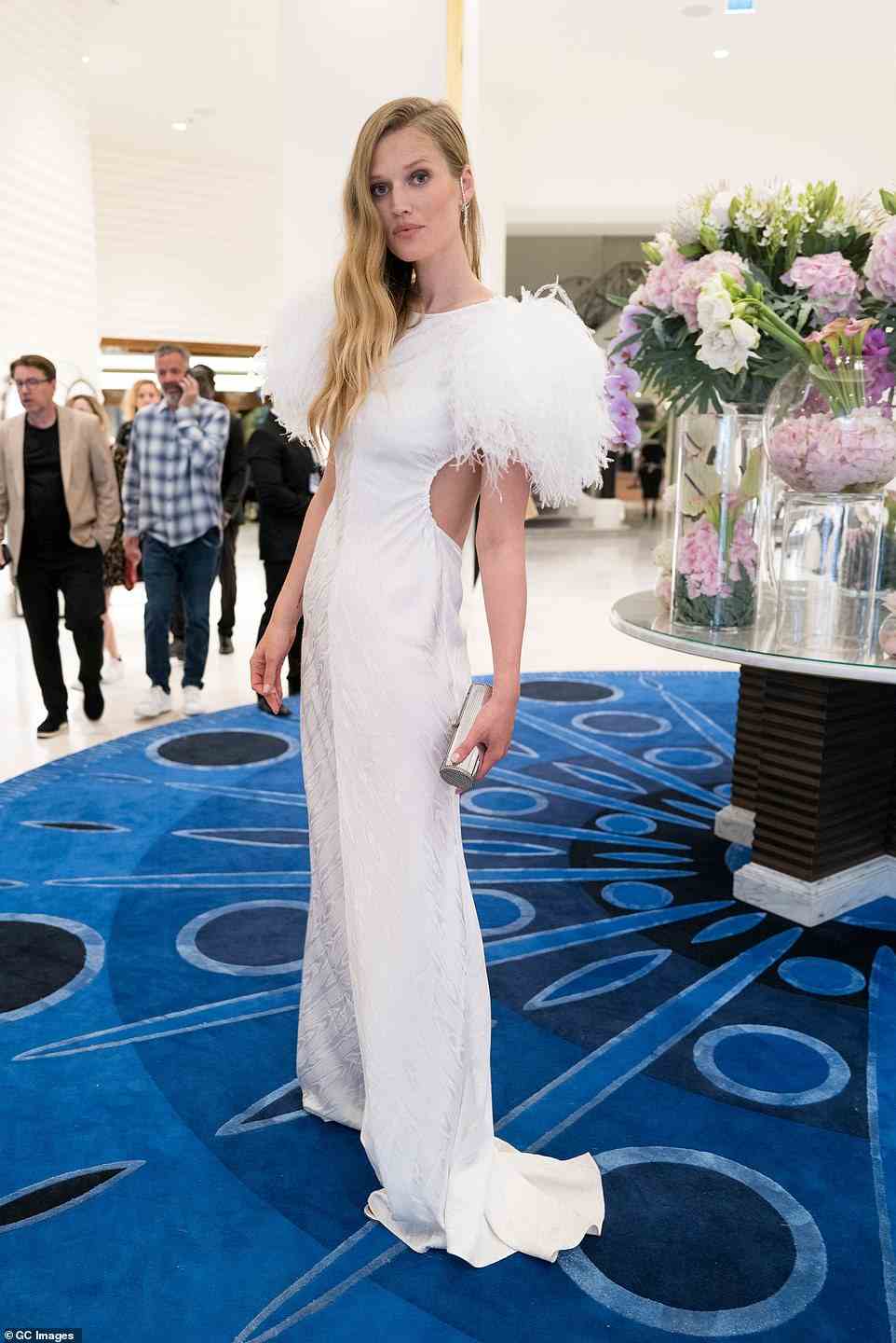 Radiant: Toni Garn looked lovely in a slinky white dress with feathered detailing