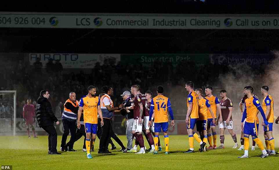 Security soon intervened when the supporters made a beeline for Mansfield players at the League Two clash on Wednesday