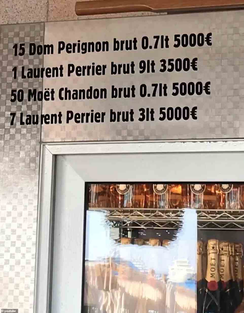 Prices for bottles of champagne are displayed on refrigerator inside the restaurant