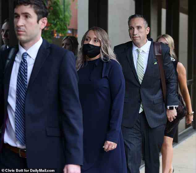 Anna, who wore a navy blue, long sleeved dress and black mask, has stood by her husband throughout the scandal