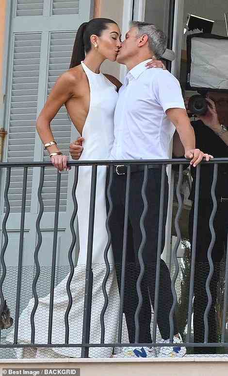 Photographers caught them sharing in a big smooch on the balcony of their hotel on Thursday; the two packed on the PDA as they soaked up the French sun in matching white outfits