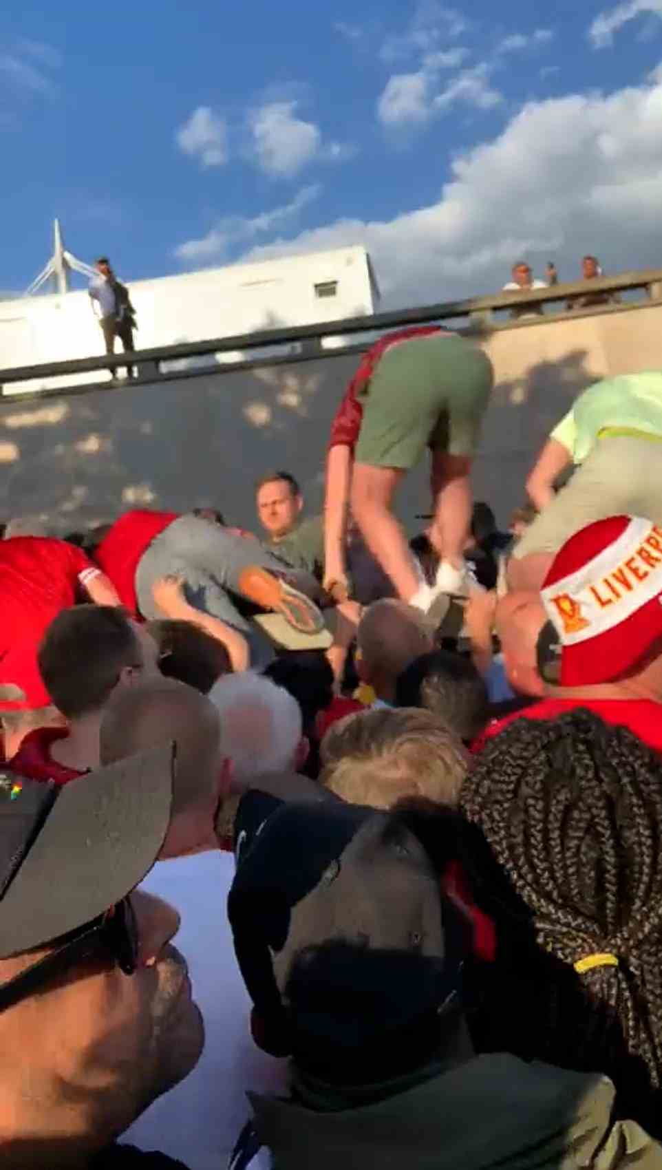 Other videos shared across social media showed the chaos outside the stadium, with Liverpool fans clambering over a wall