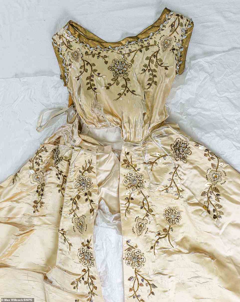 Sun-damaged: The Norman Hartnell gown had laid in storage for decades and was badly damaged due to sun exposure, pictured, before being handed over to a textile conservator