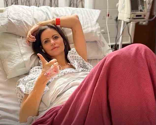 BBC podcast host Deborah James, who has incurable bowel cancer, poses from her hospital bed