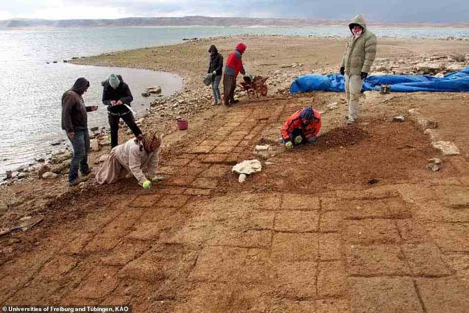 Die Lehmziegel der bronzezeitlichen Gebäude sind vom Wasser des Stausees durchnässt, können aber dennoch von Archäologen eindeutig identifiziert und freigelegt werden