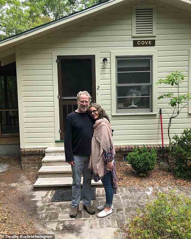 Gilbert, 58, recently traded in her glamorous lifestyle for a ramshackle cottage in the Catskill mountains with her husband, Timothy Busfield. They are pictured in front of the house