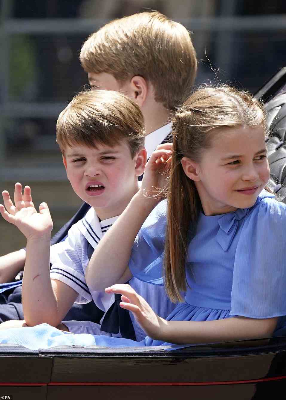 Prince Louis (pictured, centre) was snapped pulling faces while he waved animatedly at the crowd while riding a horse-drawn carriage down the Mall during today's Platinum Jubilee celebrations