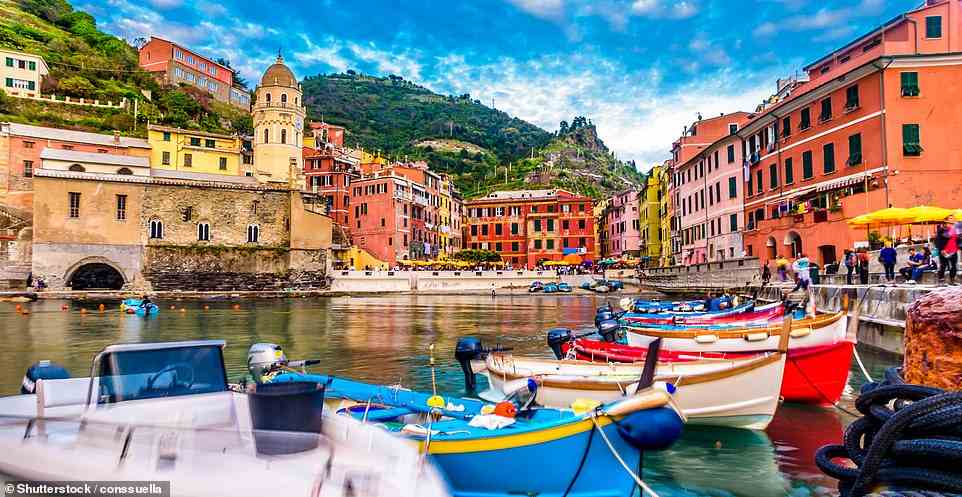 Vibrant: Above is Vernazza, one of the colourful fishing villages in Cinque Terre that can be explored by boat tour