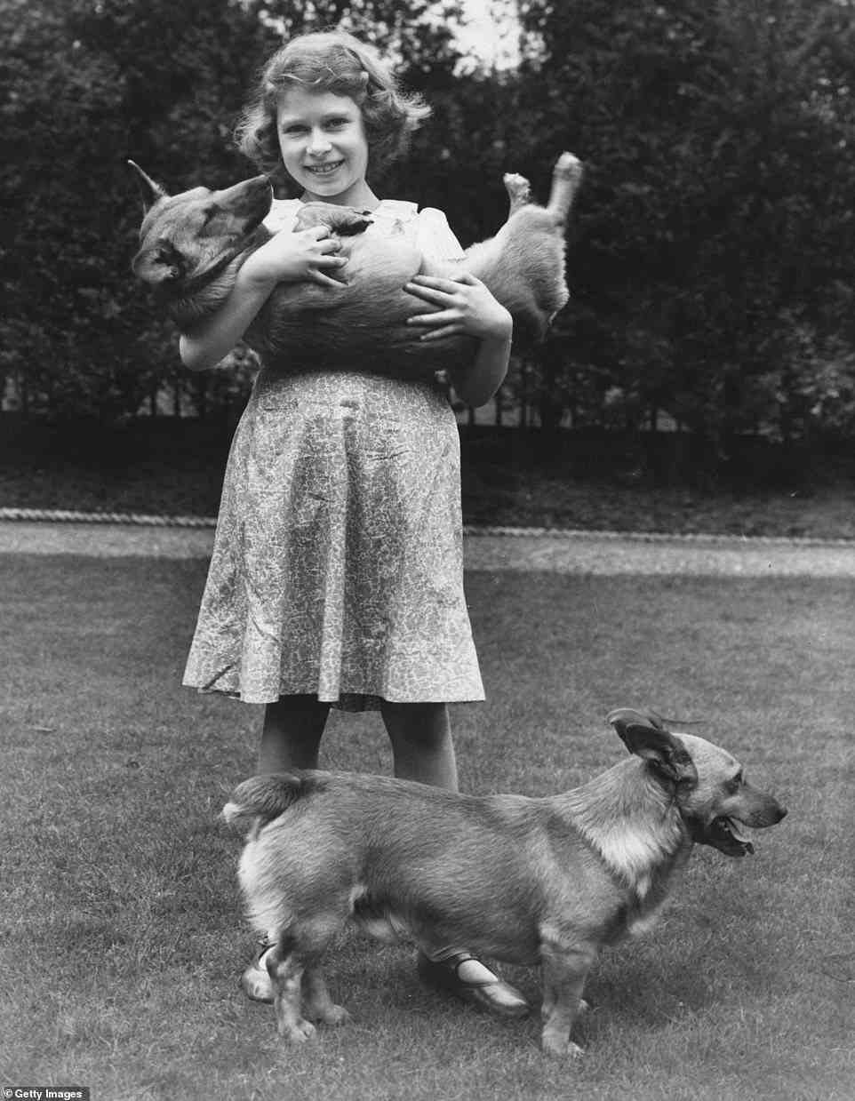 Princess Elizabeth, who grew up to become queen, with two corgi dogs at her home at 145 Piccadilly, London, July 1936