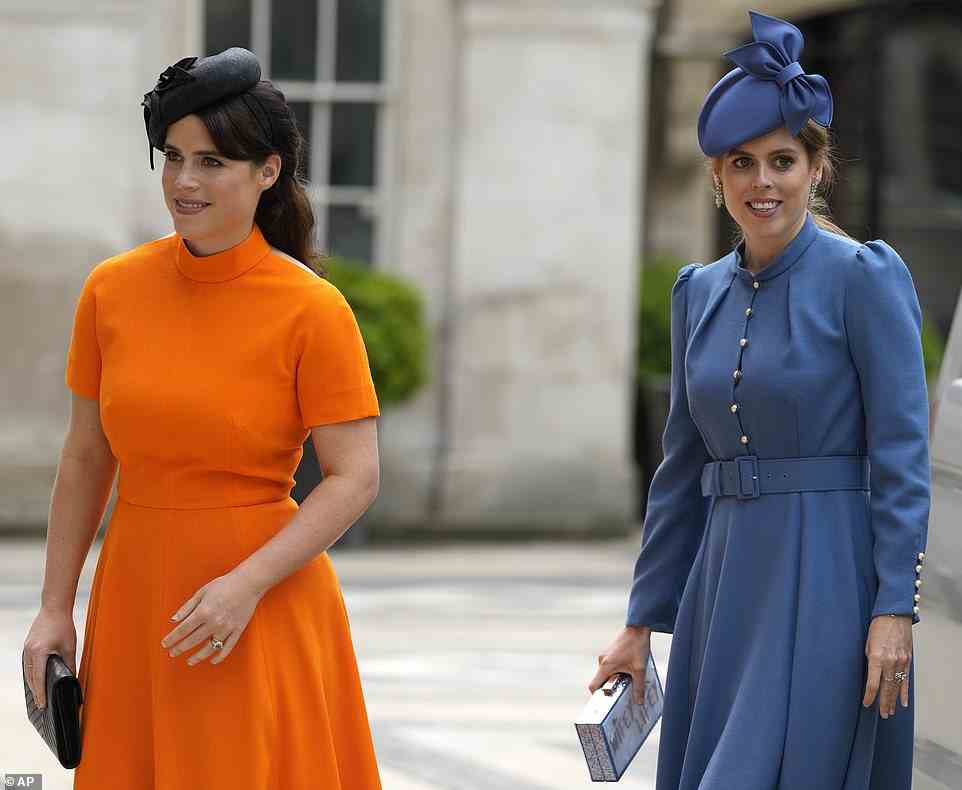 Priness Eugenie chose a vibrant orange dress with a black cocktail hat, while Beatrice was perfectly co-ordinated in shades of blue