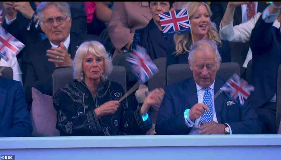 Having fun: Camilla seemed to thoroughly enjoy Jason's performance as she was seen waving her Union Jack alongside her husband Charles