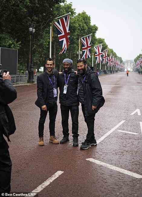 A police officer takes a photograph for a group of men on The Mall in London, June 5, 2022
